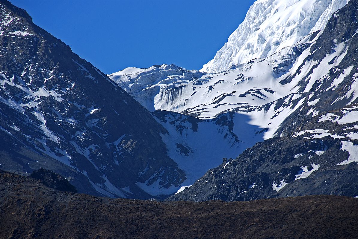 14 Steep, Ice And Snow Clad Mesokanto La The way from the base of the Mesokanto La at around 4800m is very steep at first.  Gyan scrambled up part way to confirm that it was too dangerous to ascend. I was glad when he got safely back down to us.